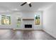 Bright living room with a fireplace, ample windows, and glass patio door at 709 Dodd Ln # 165, Buford, GA 30518