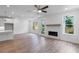 Open-concept living area features fireplace, ample windows, and access to kitchen at 709 Dodd Ln # 165, Buford, GA 30518