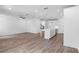 Open-concept living room and kitchen boasts sleek appliances, center island, and hardwood flooring at 709 Dodd Ln # 165, Buford, GA 30518