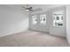 The main bedroom featuring plush carpet and abundant natural light from multiple windows at 709 Dodd Ln # 165, Buford, GA 30518