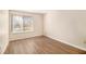 This bedroom features neutral walls, wood-look flooring, and a window at 2220 Runnymead Se Rdg, Marietta, GA 30067