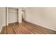 This bedroom features neutral walls, wood-look flooring, and a spacious closet at 2220 Runnymead Se Rdg, Marietta, GA 30067