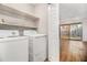 Practical laundry area with washer, dryer, and shelving for storage at 2220 Runnymead Se Rdg, Marietta, GA 30067