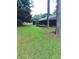 Large, level backyard featuring mature trees, a deck, and privacy fence at 5475 Morning Creek Cir, Atlanta, GA 30349