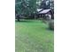 Traditional home on a spacious lot with lush green grass and mature trees at 5475 Morning Creek Cir, Atlanta, GA 30349