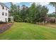 Expansive backyard with lush green grass and a wooden fence, perfect for outdoor activities at 5535 Buck Hollow Dr, Alpharetta, GA 30005