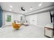Finished basement with tile flooring, modern lighting, and a cozy seating area with natural light at 5535 Buck Hollow Dr, Alpharetta, GA 30005