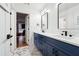 Stylish bathroom featuring double vanity with white countertop and navy blue cabinets with modern fixtures at 5535 Buck Hollow Dr, Alpharetta, GA 30005