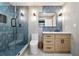 Modern bathroom with a sleek glass shower, vanity with drawers, and stylish blue geometric wallpaper at 5535 Buck Hollow Dr, Alpharetta, GA 30005