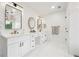 Luxurious bathroom with dual vanities, white cabinets, and decorative mirrors with tile flooring at 5535 Buck Hollow Dr, Alpharetta, GA 30005