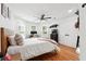 Cozy bedroom with hardwood floors, neutral tones, ceiling fan, and natural light from the windows at 5535 Buck Hollow Dr, Alpharetta, GA 30005