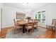 Elegant dining room with chandelier, neutral paint, area rug, and a large window providing plenty of light at 5535 Buck Hollow Dr, Alpharetta, GA 30005