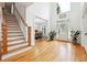 Open foyer featuring wood floors, staircase and access to the dining room at 5535 Buck Hollow Dr, Alpharetta, GA 30005