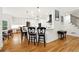 Modern kitchen featuring an island with bar stools, white cabinetry, and hardwood floors at 5535 Buck Hollow Dr, Alpharetta, GA 30005