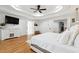Stylish main bedroom with tray ceilings, recessed lighting, hardwood floors, and a ceiling fan at 5535 Buck Hollow Dr, Alpharetta, GA 30005