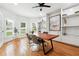 Stylish home office featuring custom built-ins, a ceiling fan, and natural light through large windows at 5535 Buck Hollow Dr, Alpharetta, GA 30005