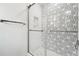 Contemporary shower with glass door and decorative tile accent wall at 5535 Buck Hollow Dr, Alpharetta, GA 30005