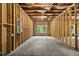 Unfinished basement with exposed framing, electrical panel, and natural light from the window at 706 Dodd Ln # 157, Buford, GA 30518