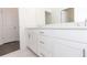 Modern bathroom featuring white cabinetry, sleek hardware, and stylish tile flooring at 706 Dodd Ln # 157, Buford, GA 30518