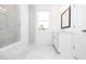 Bright bathroom with a glass-enclosed shower, marble tiling, and a scenic window view at 706 Dodd Ln # 157, Buford, GA 30518