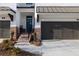 Inviting brick townhome featuring a covered front porch and two-car garage, exuding curb appeal at 706 Dodd Ln # 157, Buford, GA 30518