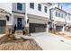 Elegant townhomes with white brick, dark metal roofs, and inviting entrances for modern living at 706 Dodd Ln # 157, Buford, GA 30518
