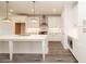 Modern kitchen featuring white cabinets, a large island, stainless steel appliances and stylish pendant lighting at 706 Dodd Ln # 157, Buford, GA 30518