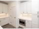 Modern kitchen offers white cabinets, stainless steel microwave, and stone countertops at 706 Dodd Ln # 157, Buford, GA 30518