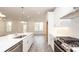 Open concept kitchen with stainless appliances, island, and view to the living area and outdoor deck at 706 Dodd Ln # 157, Buford, GA 30518