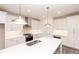 Bright kitchen features white cabinets, stainless steel appliances, and a large quartz island at 706 Dodd Ln # 157, Buford, GA 30518