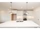 Bright kitchen boasts a large island, stainless steel appliances, white cabinets and pendant lighting at 706 Dodd Ln # 157, Buford, GA 30518