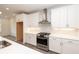 Bright kitchen featuring white cabinetry, stainless appliances, and stone countertops at 706 Dodd Ln # 157, Buford, GA 30518