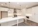 Modern kitchen featuring white cabinets, a large island, stainless steel appliances and stylish pendant lighting at 706 Dodd Ln # 157, Buford, GA 30518