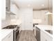 Contemporary kitchen with white cabinets, quartz countertops, and stainless steel gas range at 706 Dodd Ln # 157, Buford, GA 30518