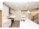 Modern kitchen with white cabinetry, stainless steel appliances, and a center island with sink at 706 Dodd Ln # 157, Buford, GA 30518