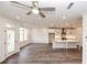 Bright living space with gray floors leading to a modern kitchen with island seating at 706 Dodd Ln # 157, Buford, GA 30518