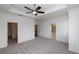 Expansive main bedroom with neutral carpet, tray ceiling, and doorway to walk-in closet at 706 Dodd Ln # 157, Buford, GA 30518
