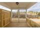 Inviting covered porch with wooden deck, railing, and a view of the wooded neighborhood at 706 Dodd Ln # 157, Buford, GA 30518