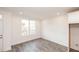 Bright room with window overlooking treeline, grey wood-look floors and white walls and trim at 706 Dodd Ln # 157, Buford, GA 30518