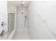 Modern marble shower with glass enclosure and updated fixtures at 706 Dodd Ln # 157, Buford, GA 30518