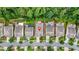Aerial view showcases the layout of houses with green lawns and mature trees at 728 Lorimore Pass, Canton, GA 30115