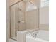 Bathroom featuring a glass shower and soaking tub at 728 Lorimore Pass, Canton, GA 30115