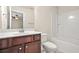 Bathroom featuring a vanity with dark wood cabinets and a shower-tub combination at 728 Lorimore Pass, Canton, GA 30115