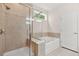 Bathroom featuring a glass shower, soaking tub, and tiled walls at 728 Lorimore Pass, Canton, GA 30115