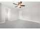 Spacious bedroom features a ceiling fan, neutral walls, gray carpeting and an attached closet for easy storage at 728 Lorimore Pass, Canton, GA 30115