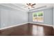 Bedroom with hardwood floors and a bright window overlooking the backyard at 728 Lorimore Pass, Canton, GA 30115