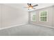 Bright bedroom features neutral walls, plush gray carpet, a ceiling fan and two windows offering natural light at 728 Lorimore Pass, Canton, GA 30115