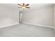 Bright bedroom features neutral walls, plush gray carpet, a ceiling fan and a doorway to another room at 728 Lorimore Pass, Canton, GA 30115