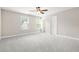 Bright bedroom features neutral walls, plush gray carpet, a ceiling fan and two windows offering natural light at 728 Lorimore Pass, Canton, GA 30115