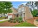 Charming two-story home featuring a manicured lawn, brick accents, and a welcoming front porch at 728 Lorimore Pass, Canton, GA 30115